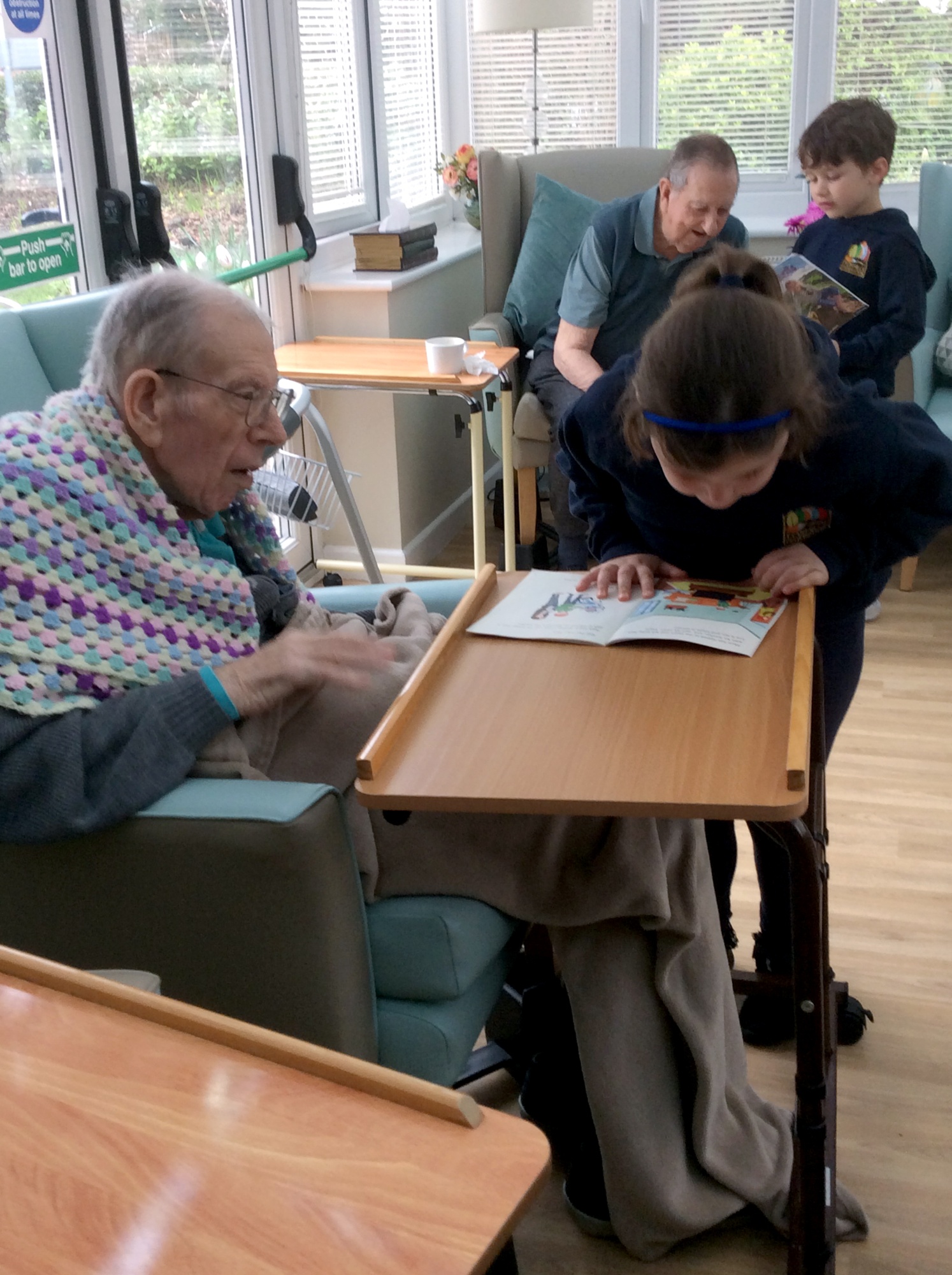 Children meeting with elderly care home residents.