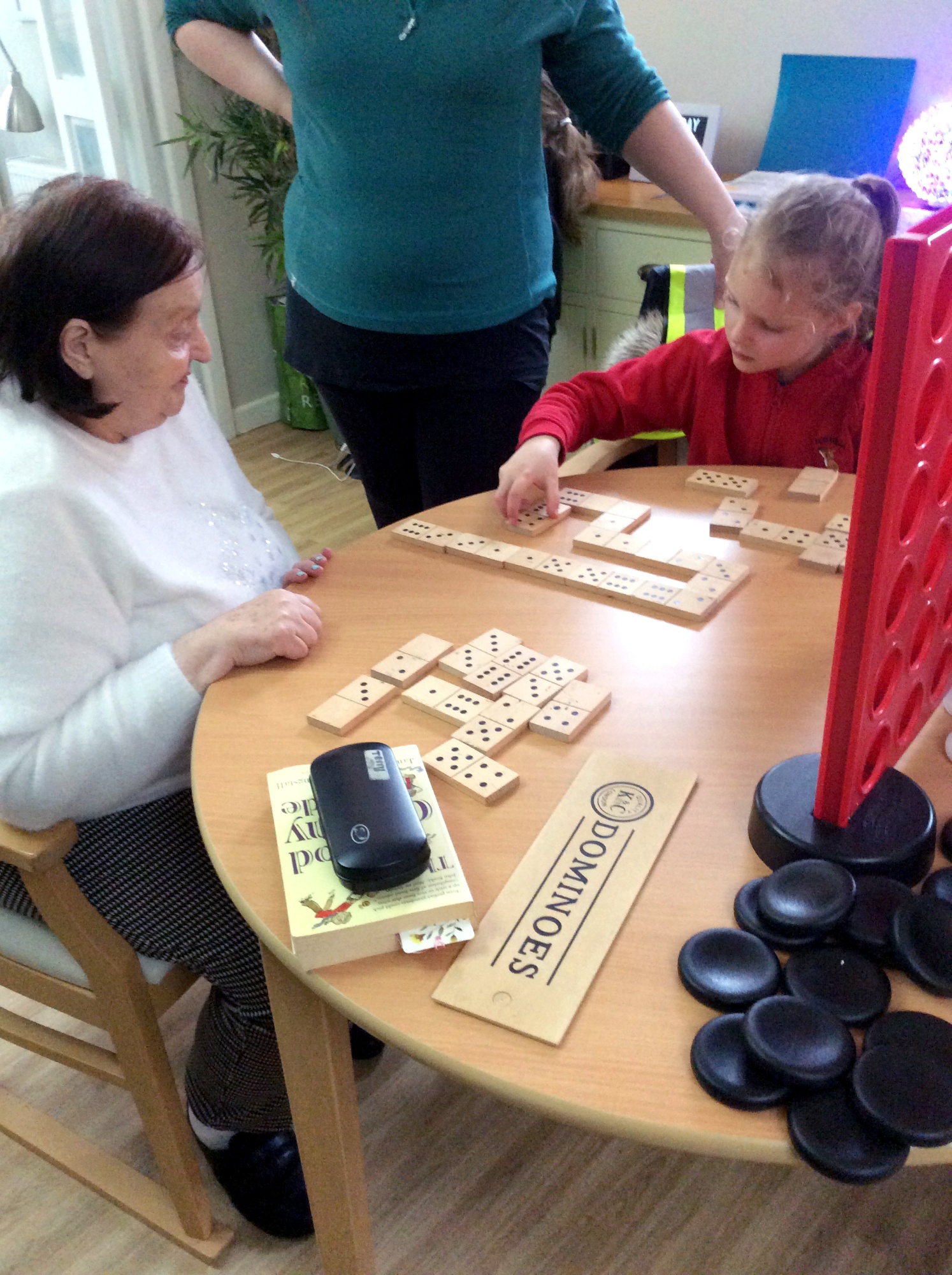 Children meeting with elderly care home residents.