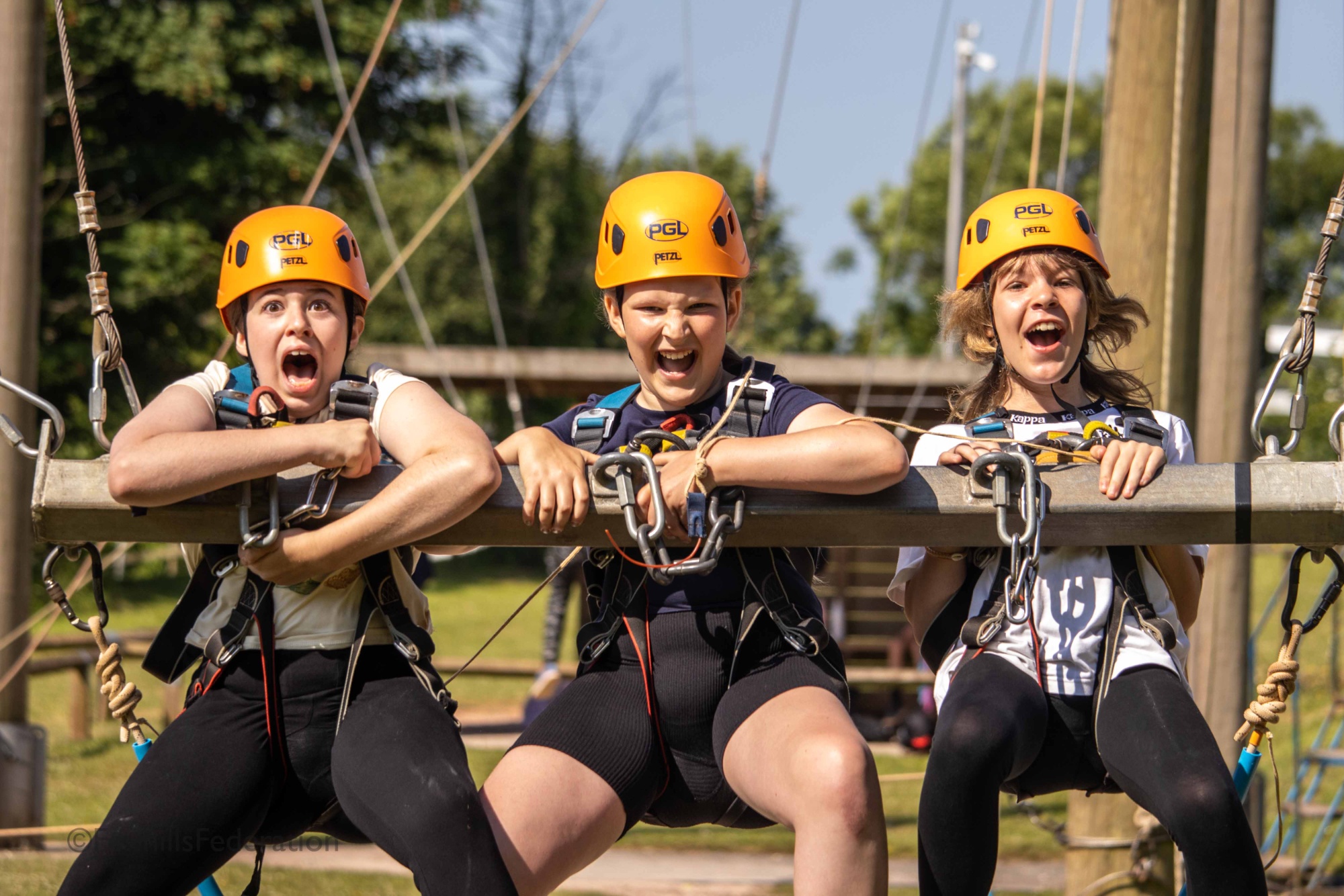 Two girls scream as they enjoy the giant swing