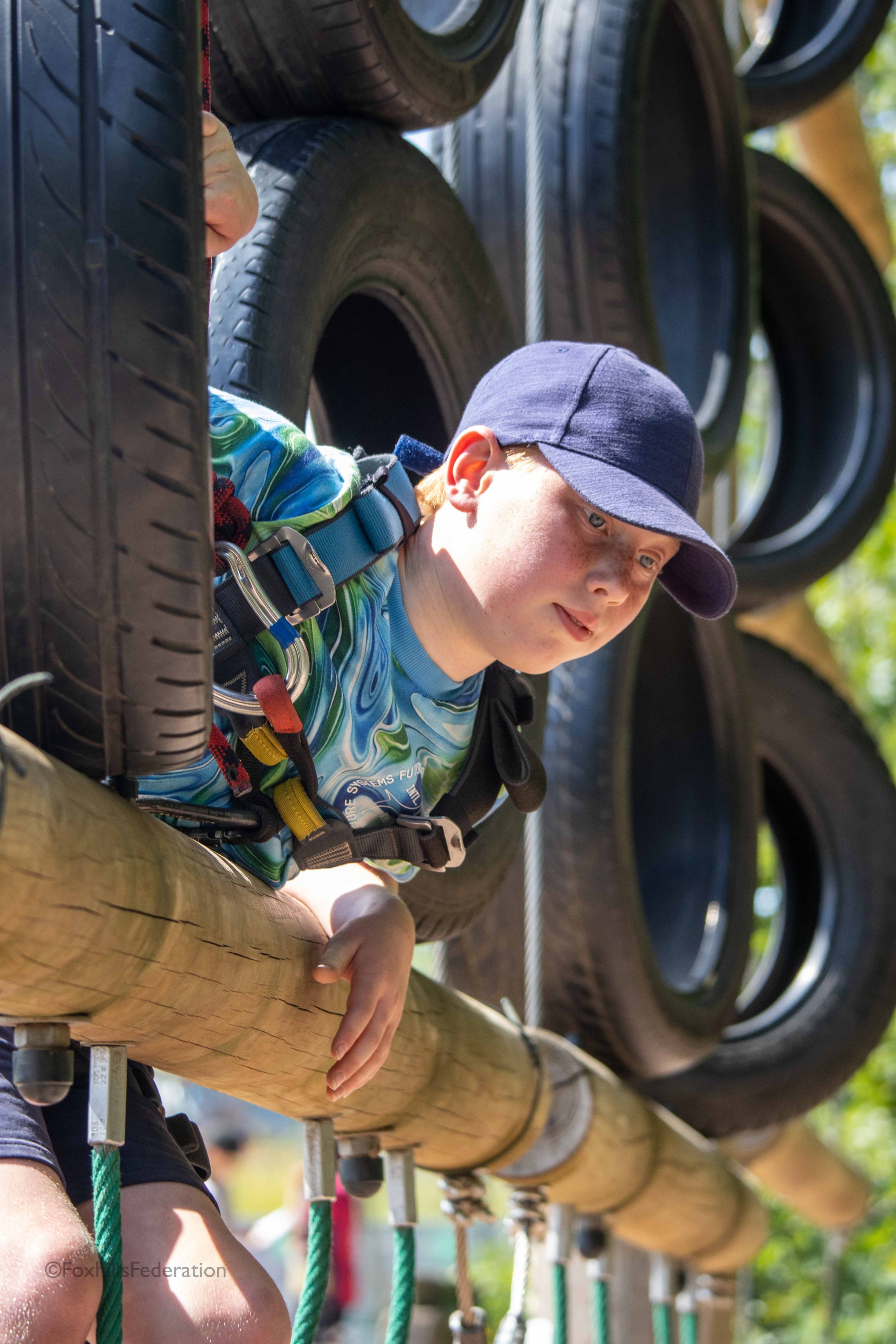 A boy climbs a tower