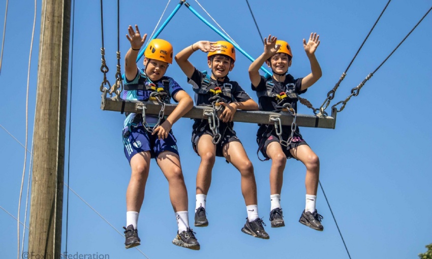 Boys enjoy a trip on the giant swing